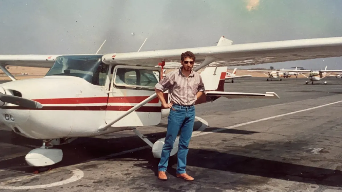 Mark Dawe, the founder's father, photographed beside his aircraft in Namibia